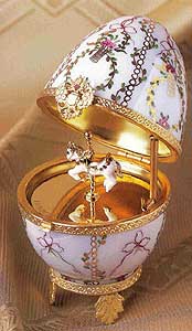 A reproduction of the original Gatchina Palace Egg made by Faberge in 1901. Made of hand painted Limoges porcelain, the egg opens to reveal an enameled Carousel Horse surprise (24k gold-plated sterling silver)